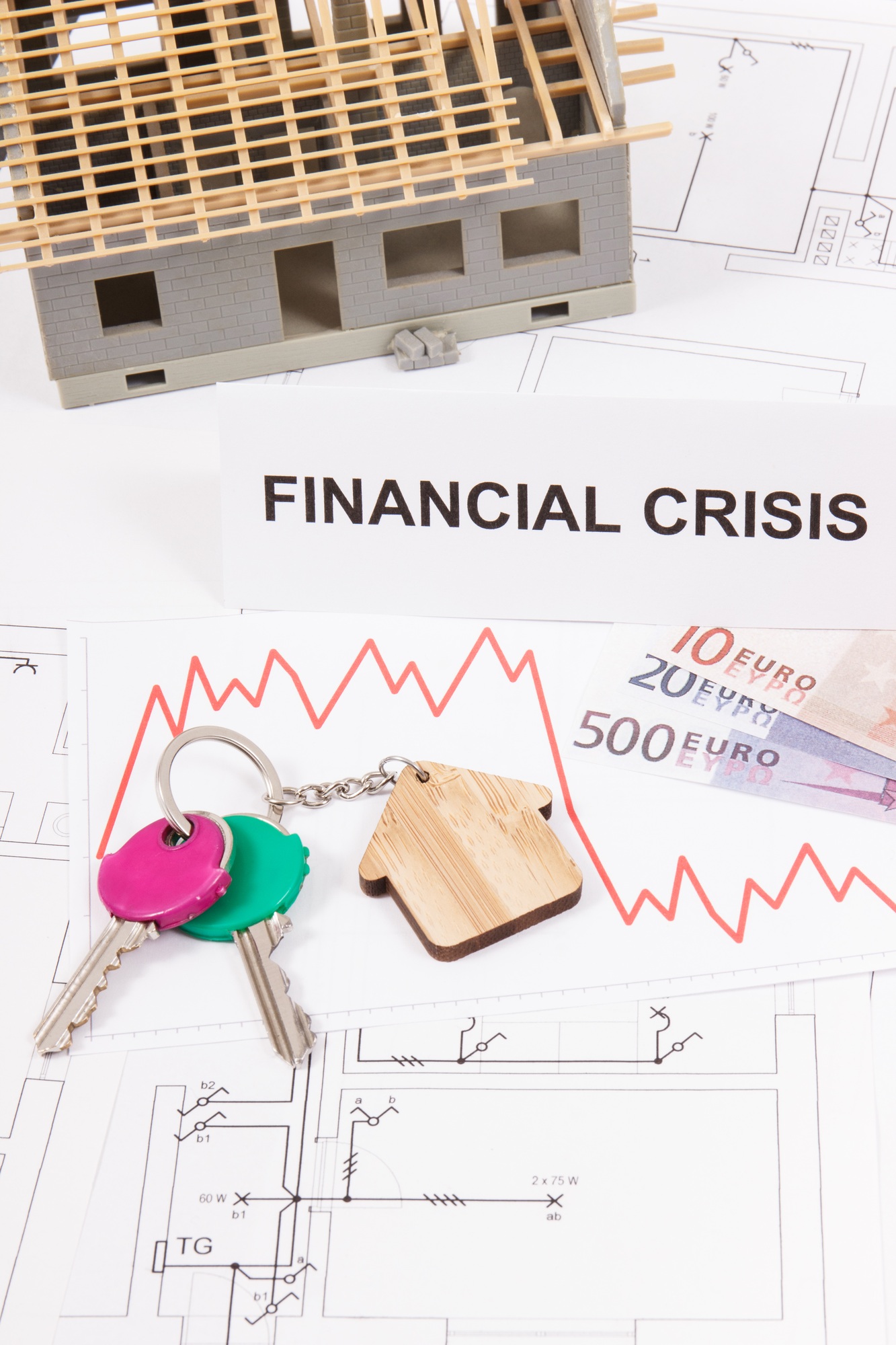 Keys with home shape, euro, downward graphs and inscription financial crisis