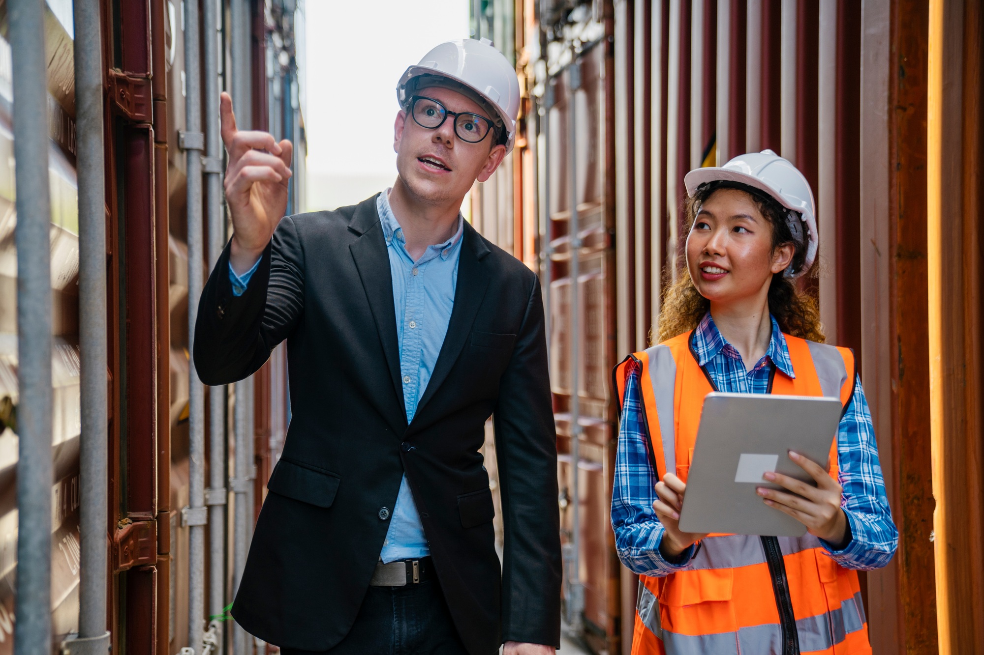 Manager and container worker working in the construction container yard