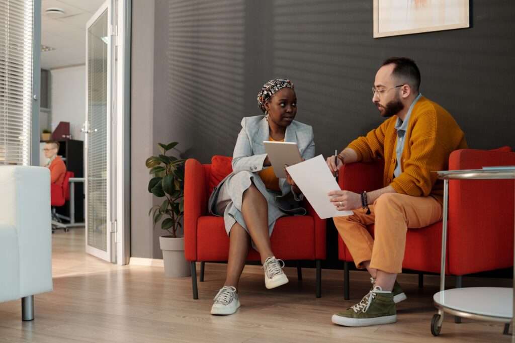Office Workers Reviewing Plans in Lounge Area